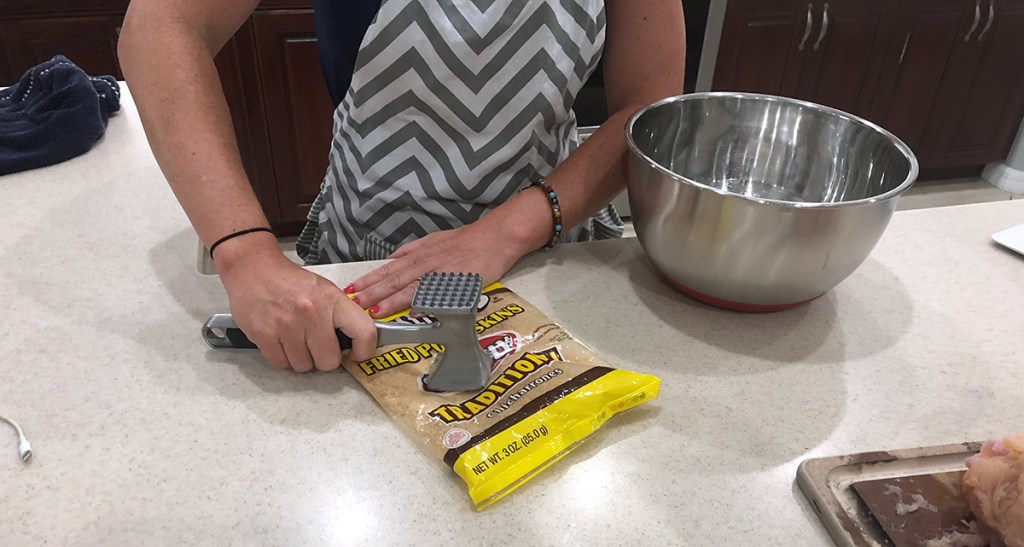 using metal tenderizer to crush pork rinds