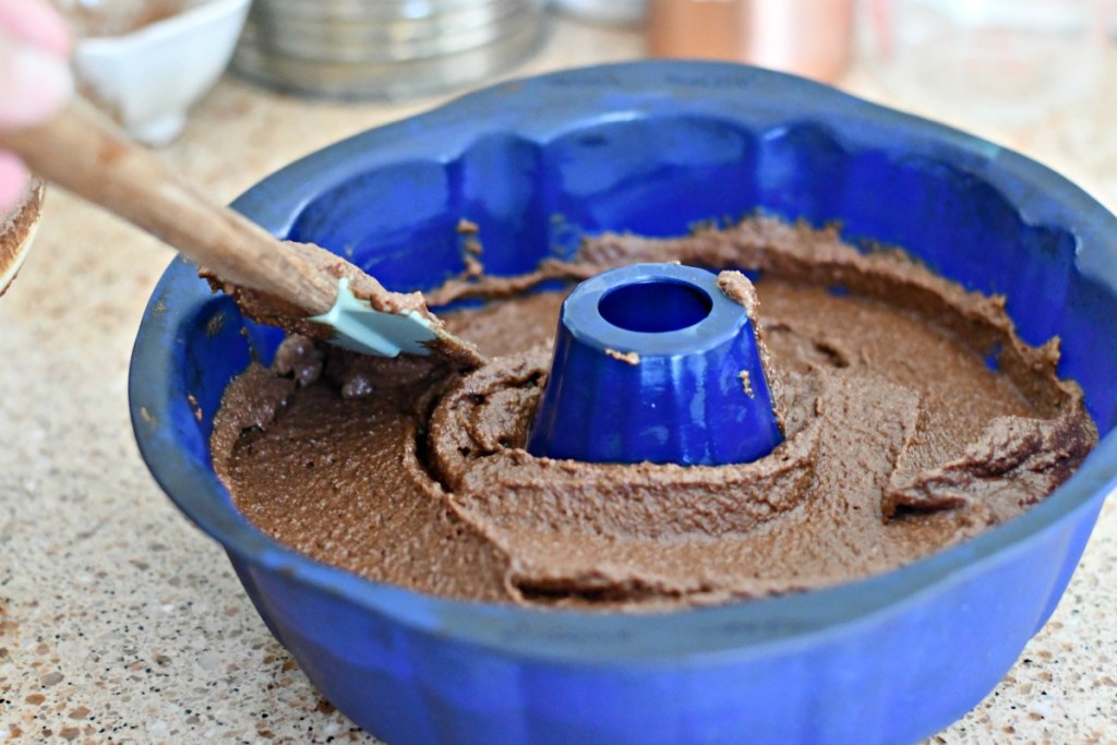 pouring keto chocolate cake into a bundt pan