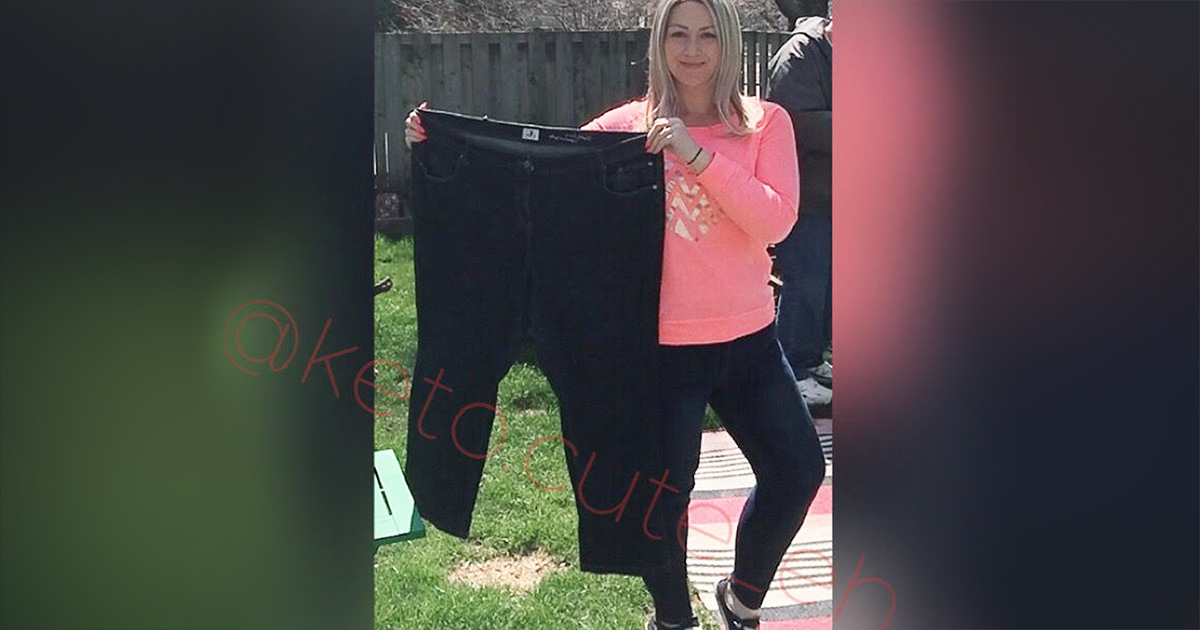sarah holding up larger jeans showing keto weight loss