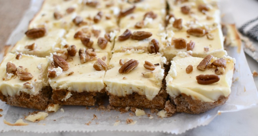 sliced keto pecan cheesecake bars on parchment paper 