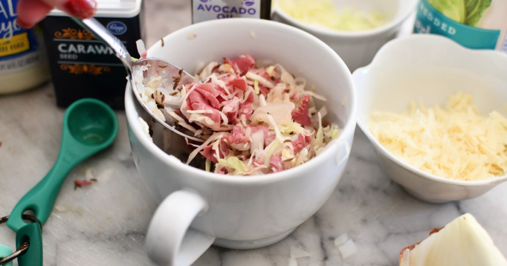 stirring reuben in a mug