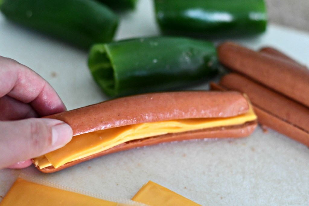 stuffing a hot dog with cheese