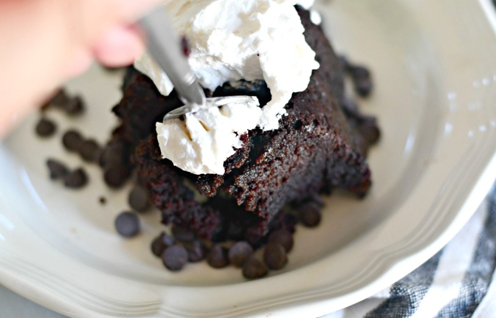 taking a bite of keto chocolate cake