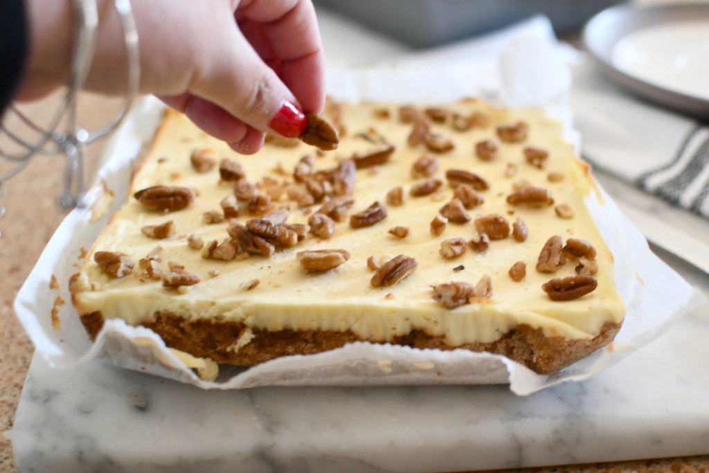 topping cheesecake bars with extra pecans