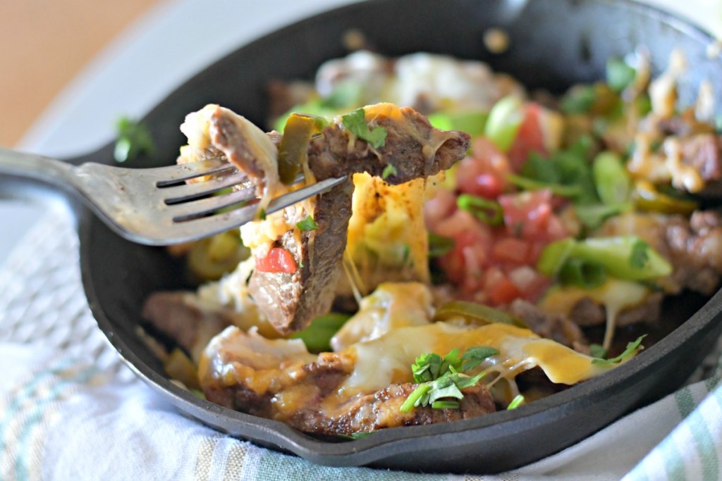 using a fork to eat skillet nachos, a low carb mexican food