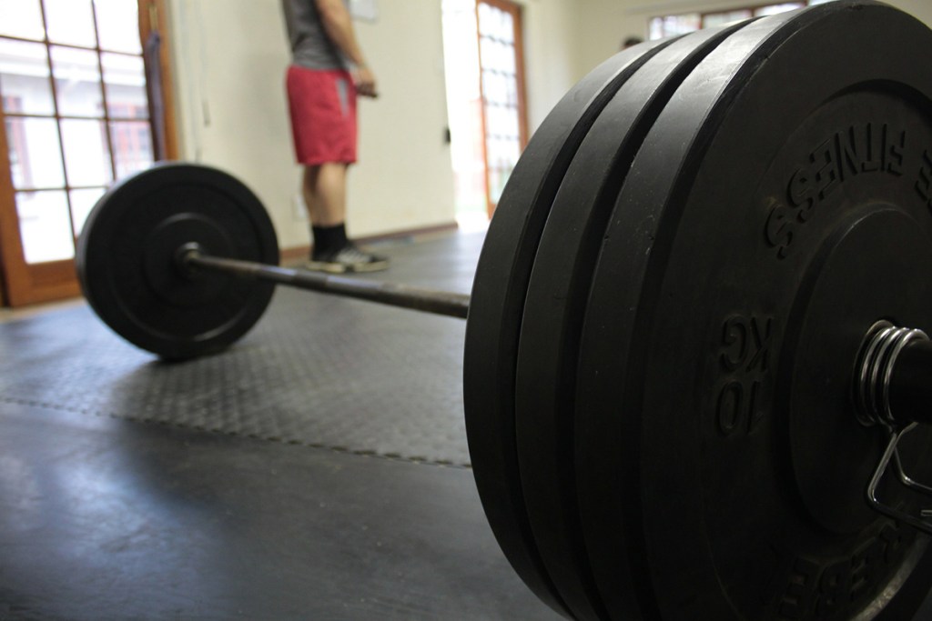 close up of bar with weights at gym