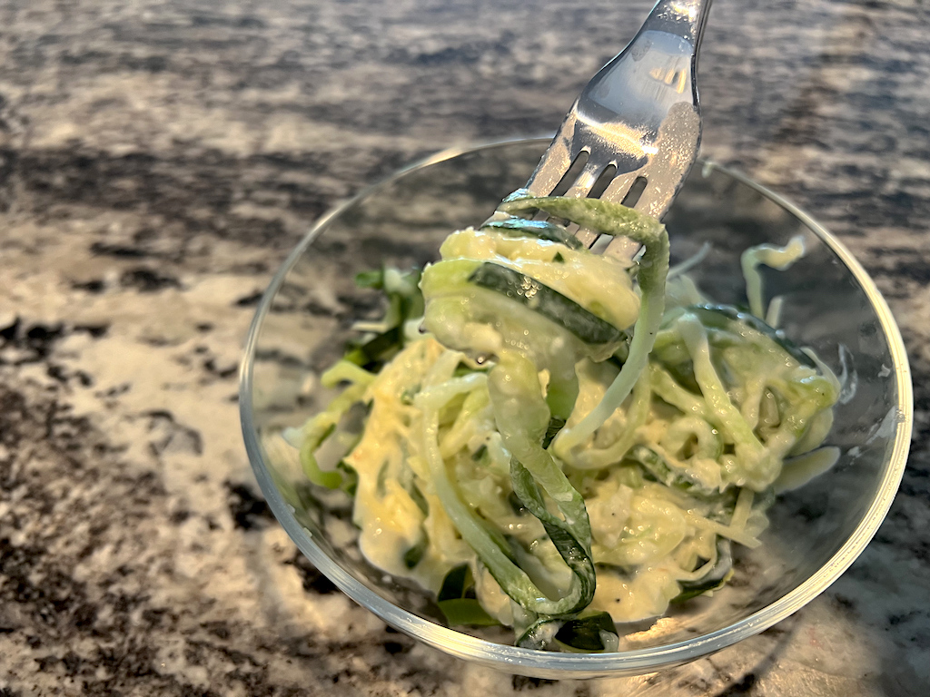 noodles in a bowl with alfredo sauce 