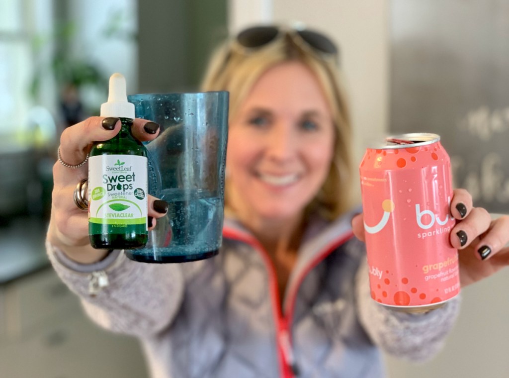 woman holding bubly sparkling water and stevia drops