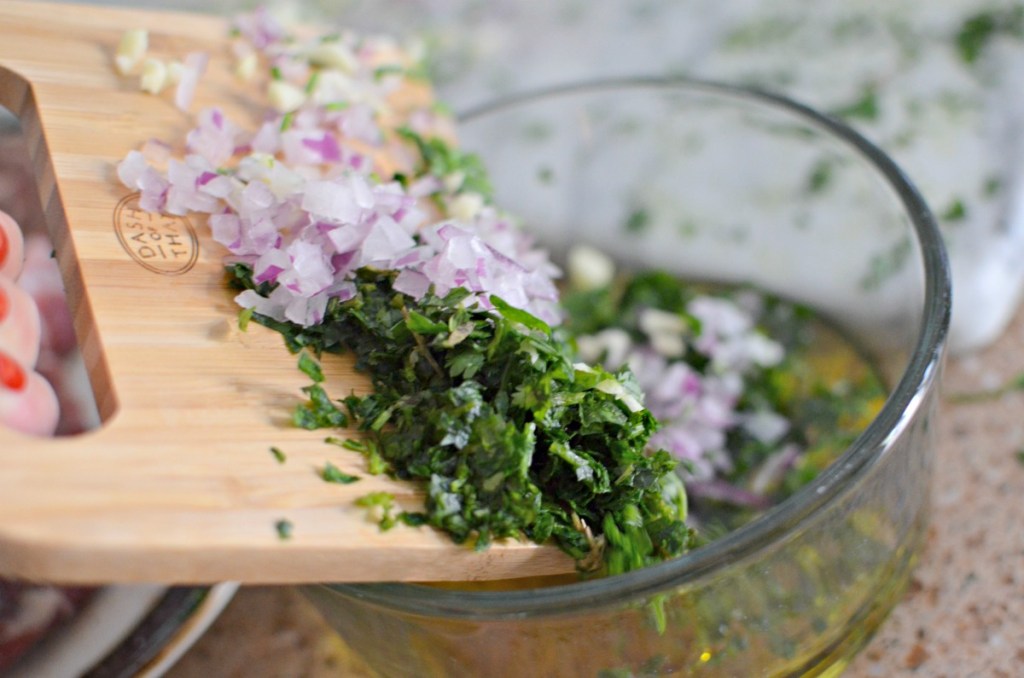 chopping ingredients for chimichurri sauce