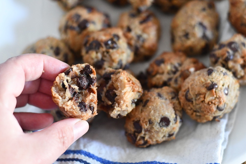 holding keto coconut cookies with chocolate chips 