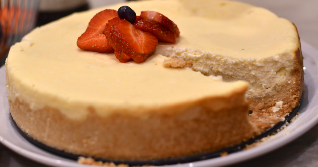 keto sugar free cheesecake on plate with berries in the center 