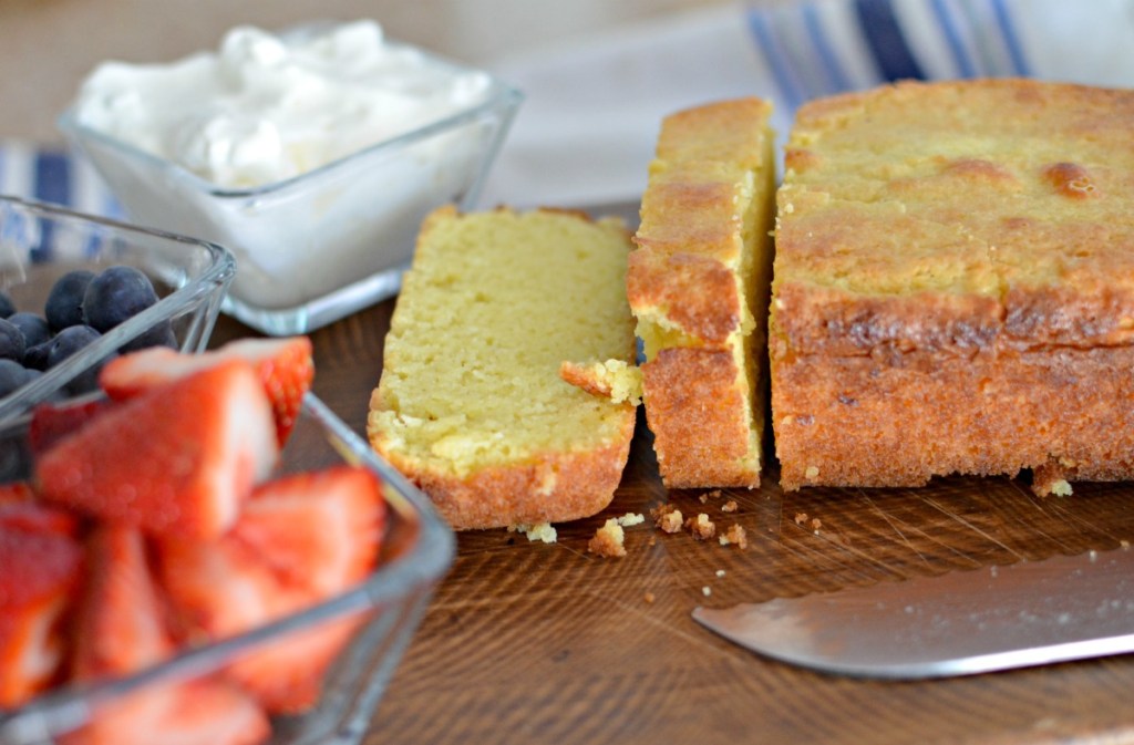 sliced keto lemon pound cake on a cutting board 