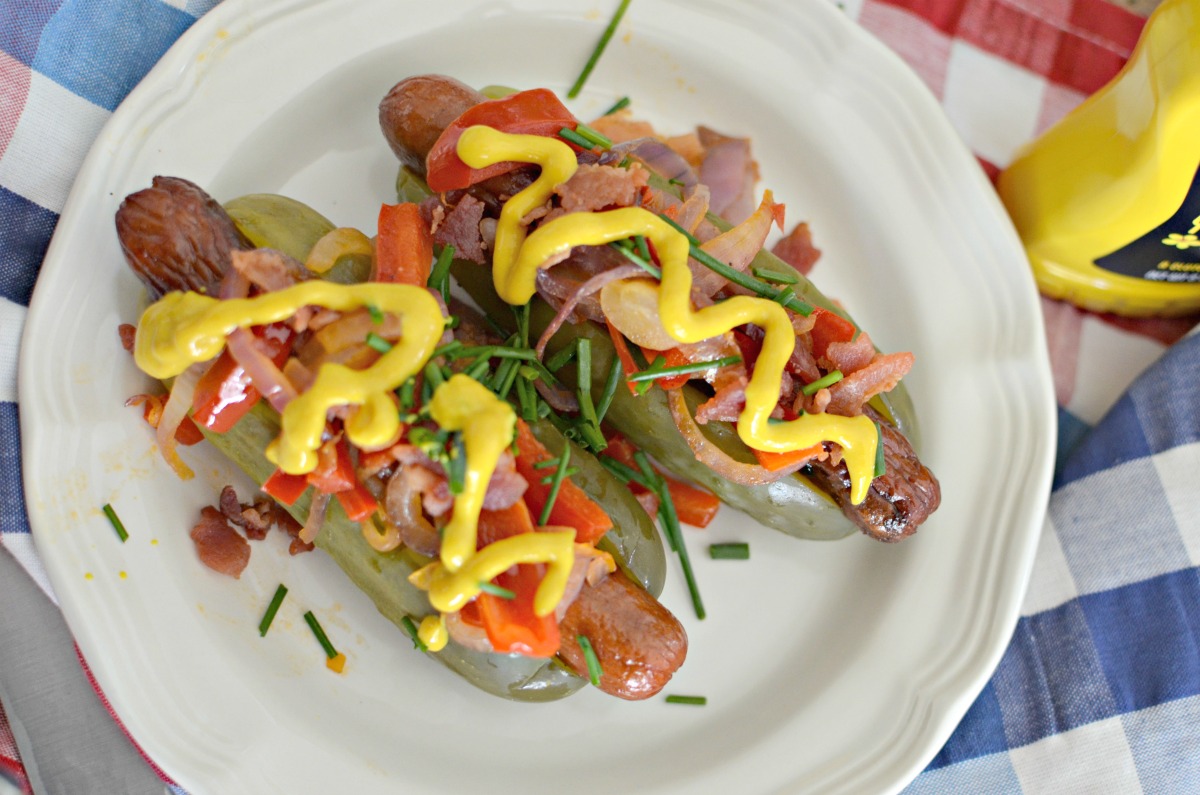 pickle hot dogs, plated with condiments