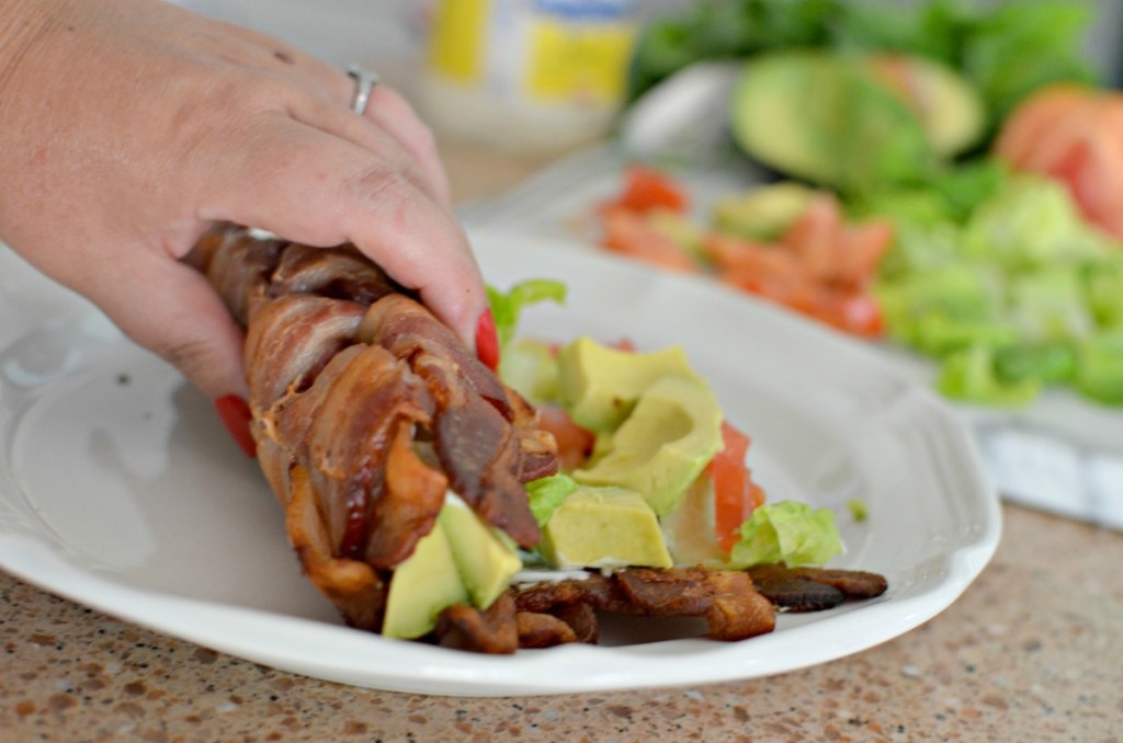 rolling up bacon weave sushi on a plate