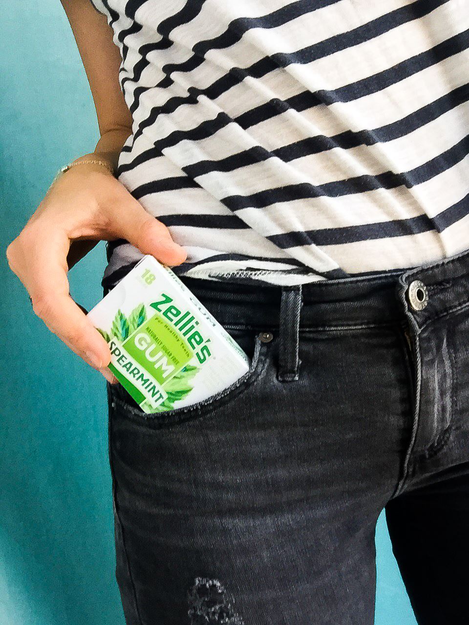 pulling pack of Zellie's gum from jeans pocket