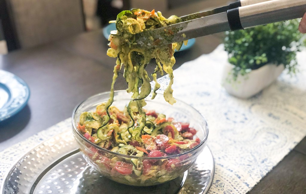 pulling up zucchini summer salad with tongs