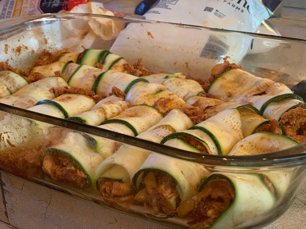large casserole filled with zucchini enchiladas 