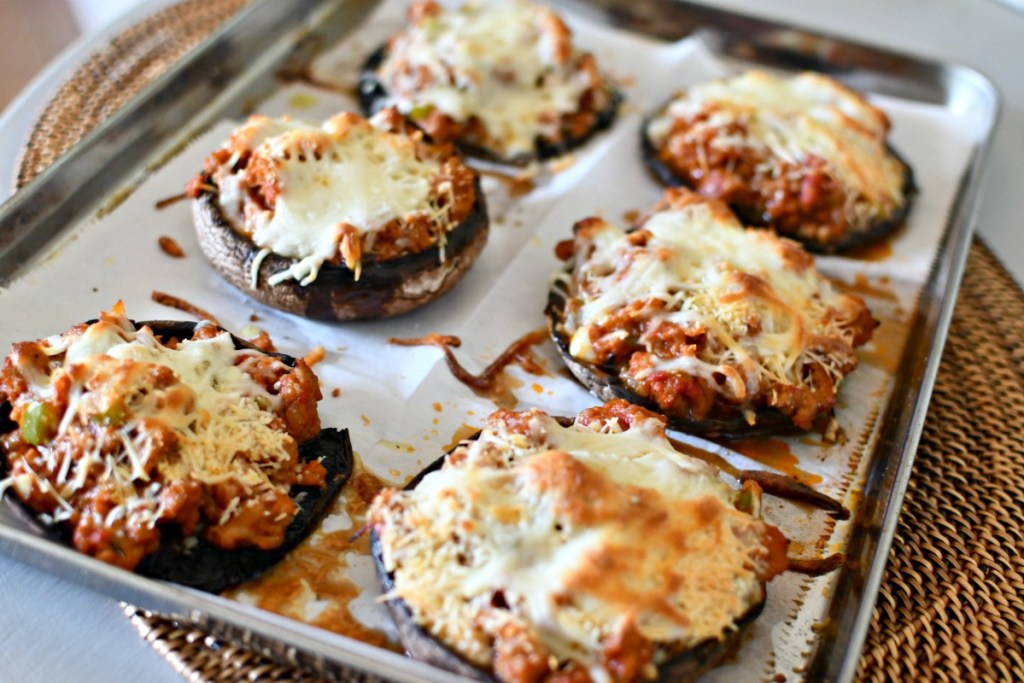 keto sausage stuffed portabella mushrooms on a sheet pan