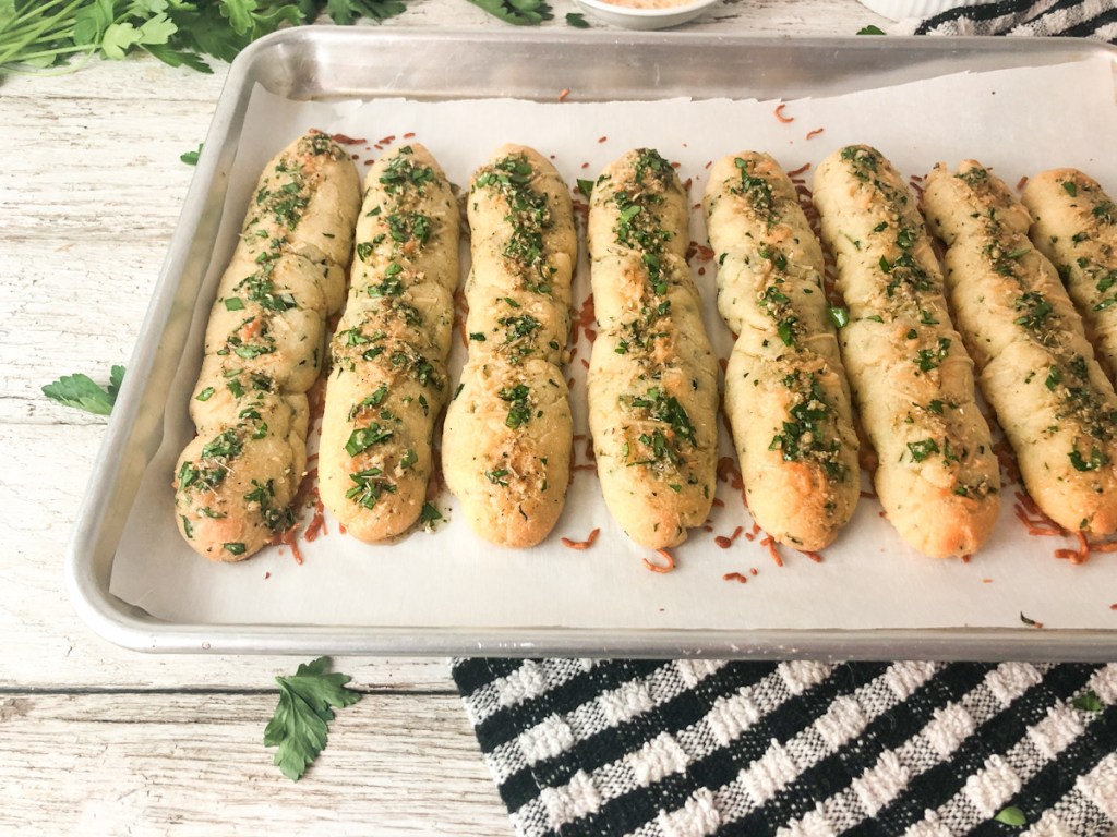 cooked keto breadsticks on baking sheet