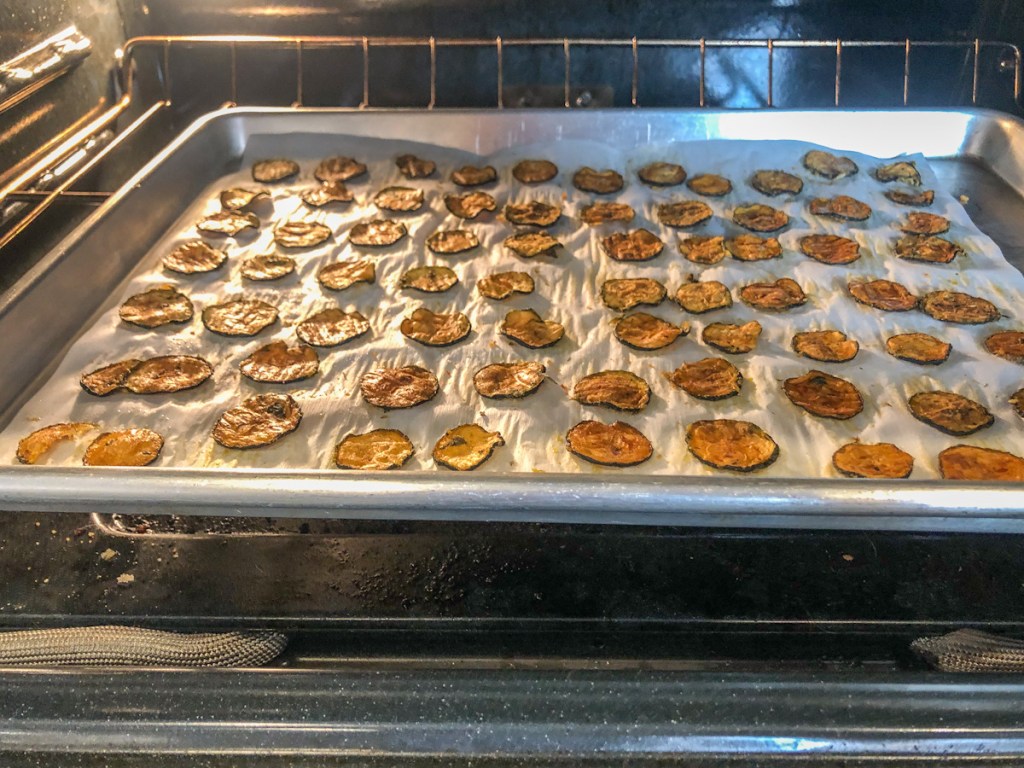 keto zucchini chips on a baking sheeting the oven