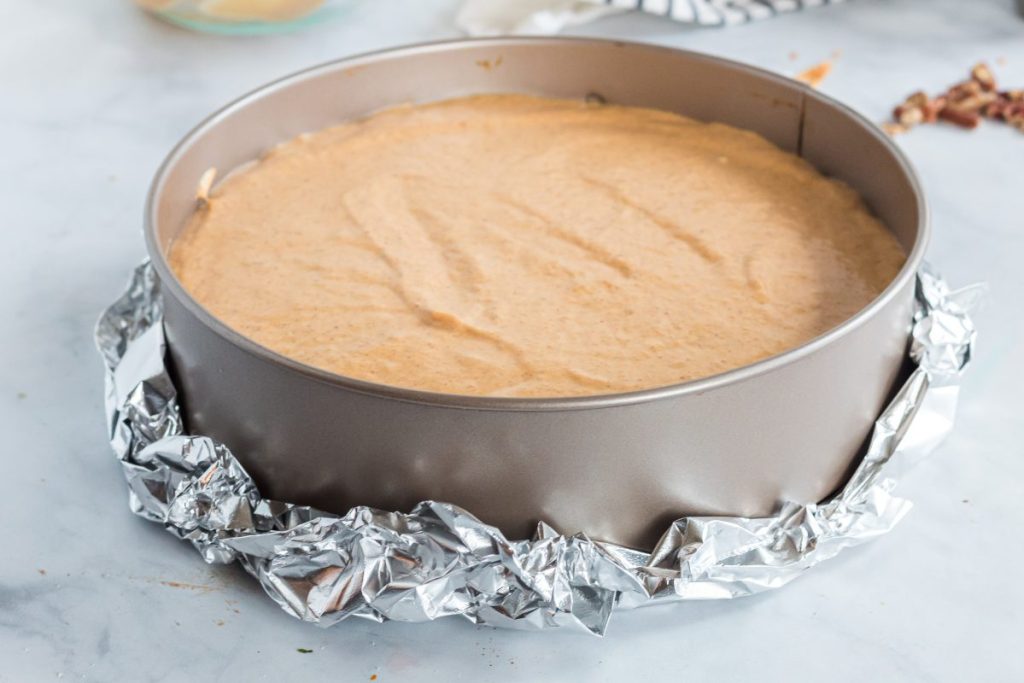 pumpkin cheesecake in foil for waterbath pan