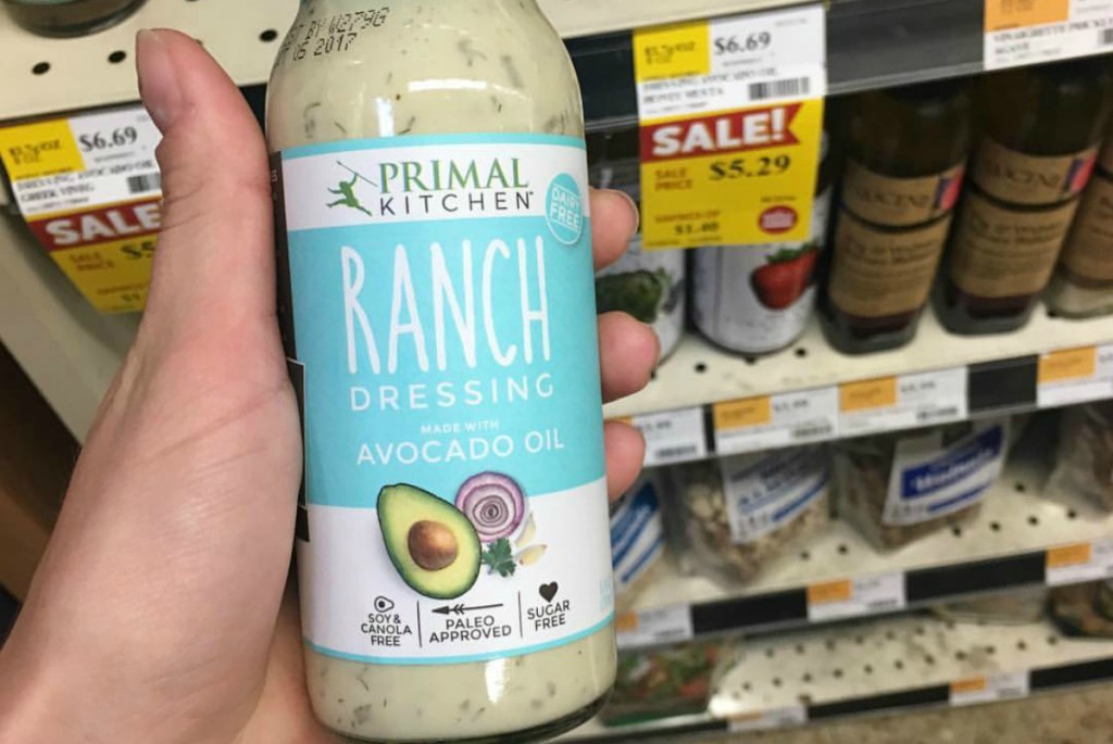 holding Primal Kitchen ranch salad dressing bottle
