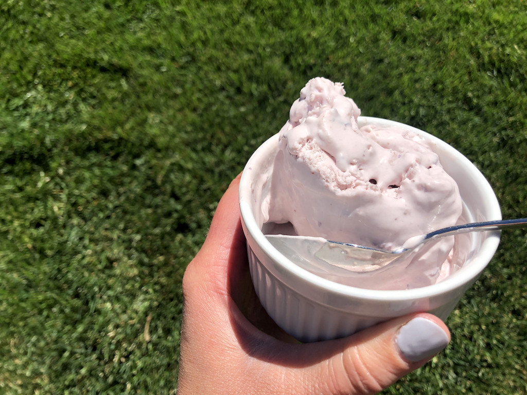 holding berry mason jar ice cream