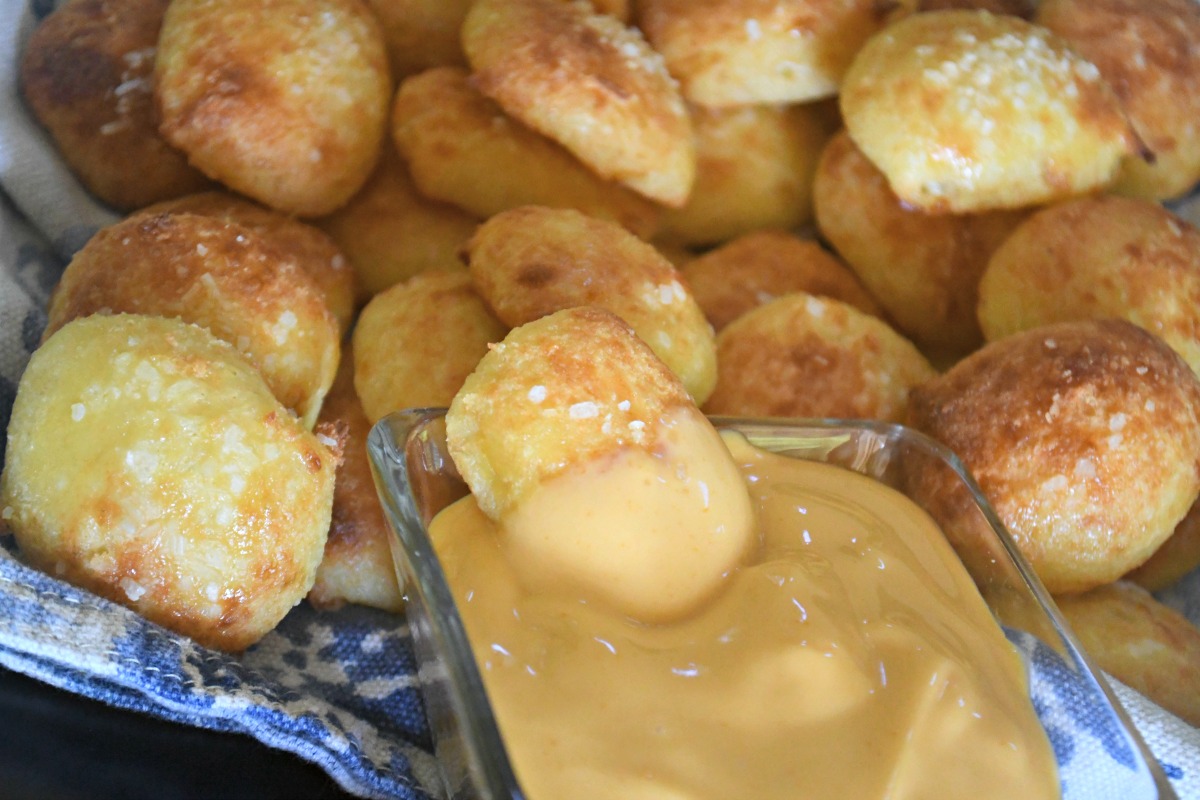 keto pretzel bites dipped into cheese sauce