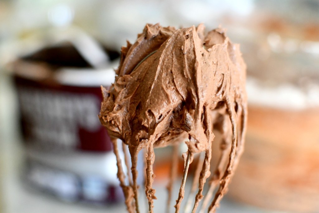 whisk with chocolate keto frosting