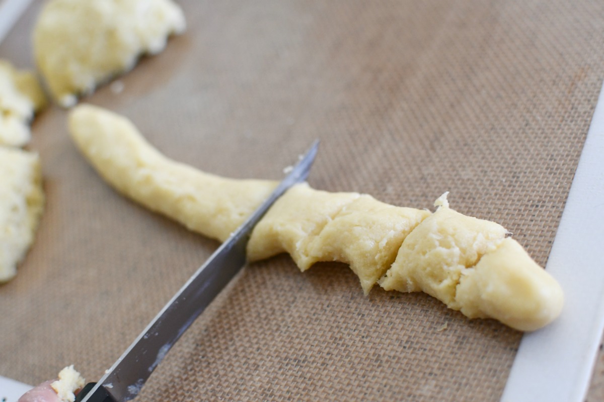 cutting dough to make keto pretzel bites