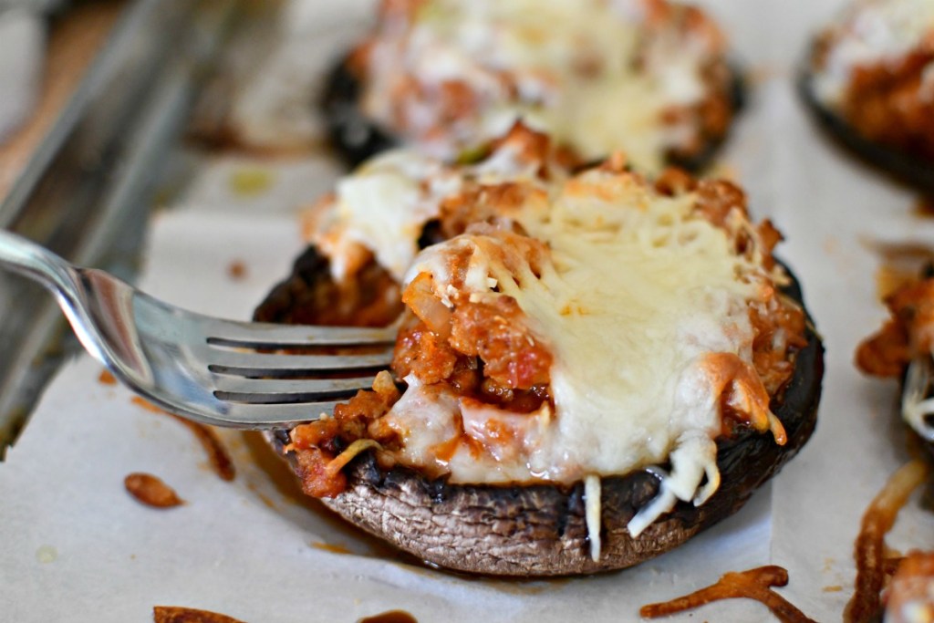 eating a bite of stuffed mushroom