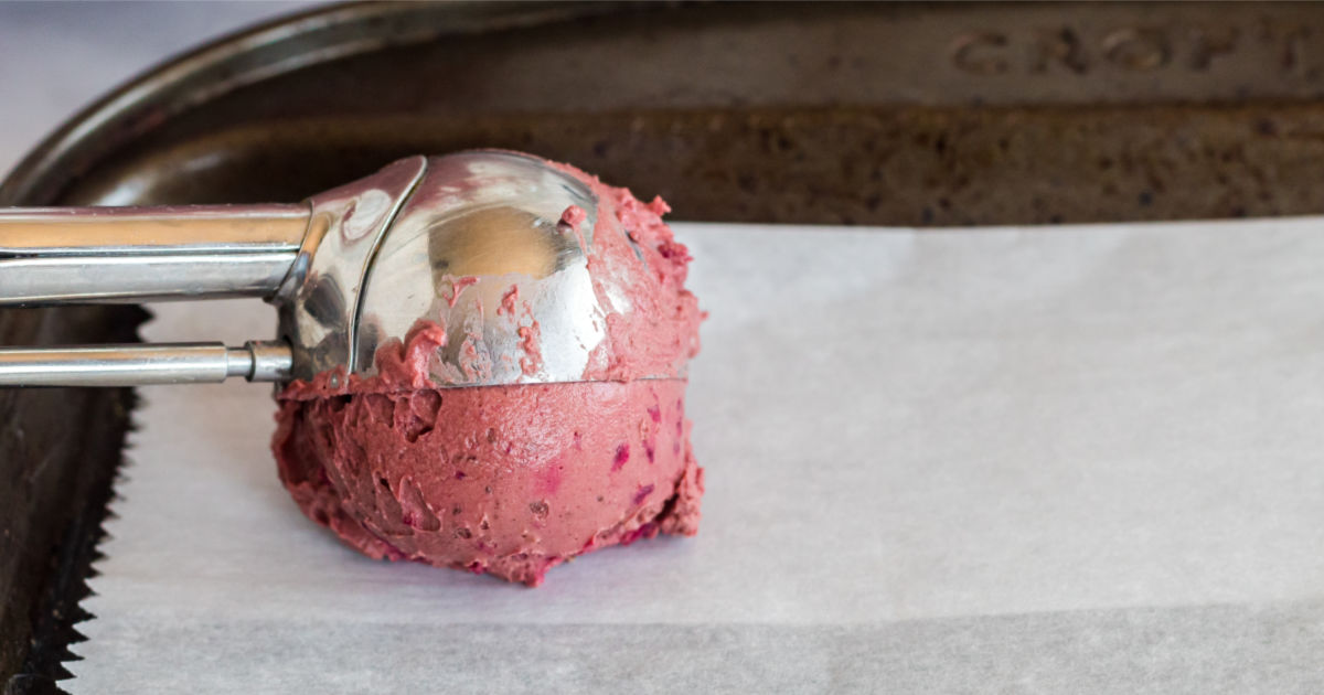 scooping the red velvet mixture onto parchment