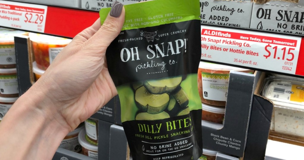 holding Oh Snap! Dill pickles snacks 