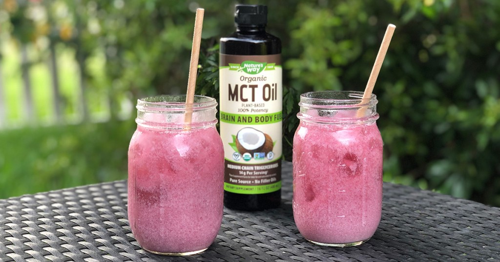 keto purple drink in glasses with bottle of mct oil