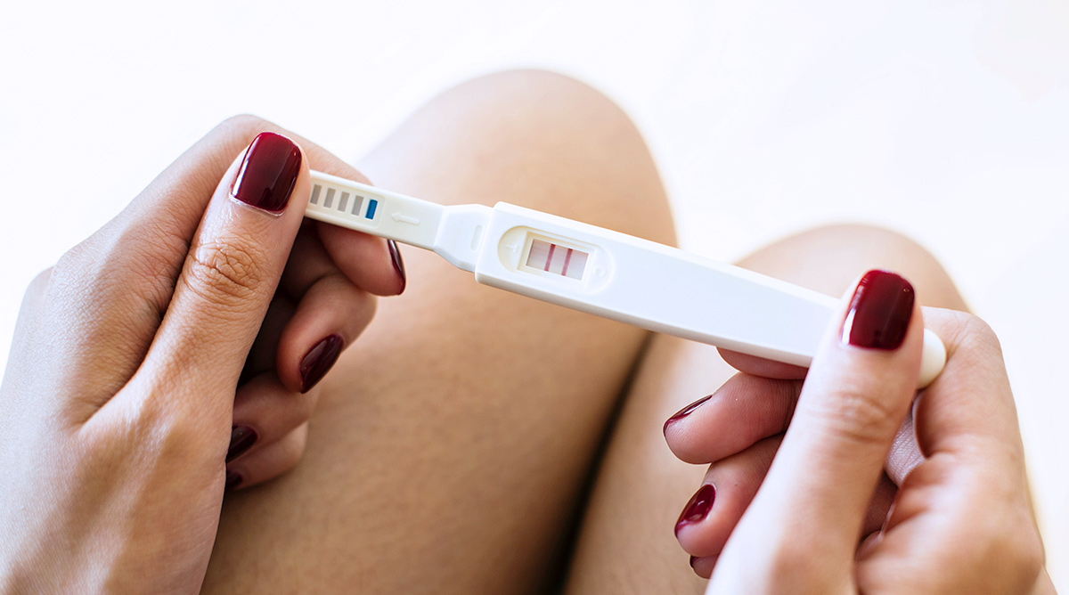 pregnancy test in hand with a positive outcome