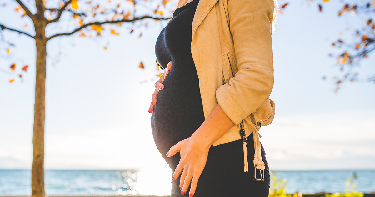 Pregnant woman holding her belly