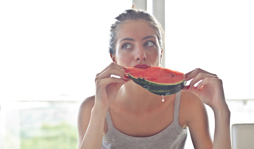 woman eating watermelon slice