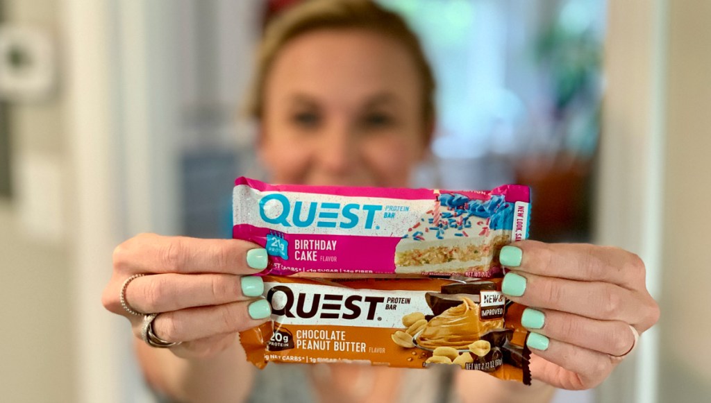 woman holding Quest protein bars