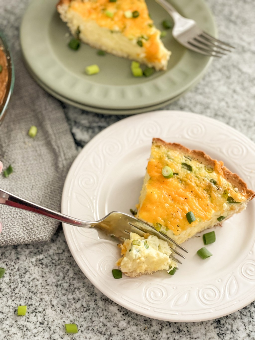 cutting into keto quiche with a fork to take a bite