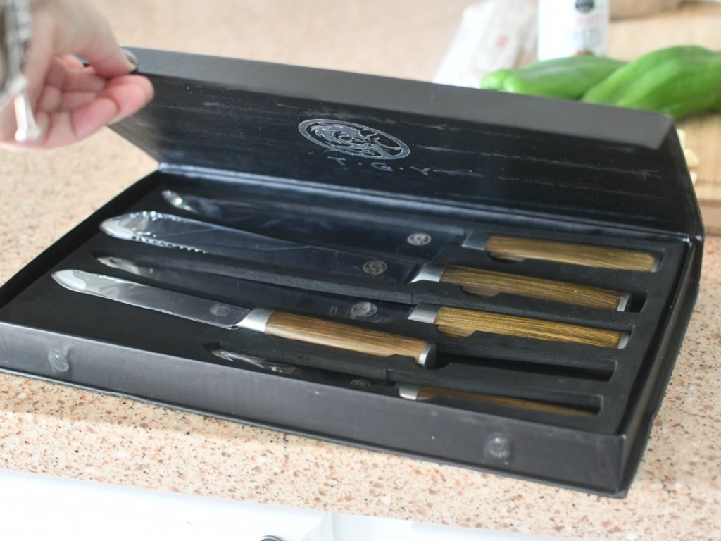 Woman opening box of T·G·Y Knife Set