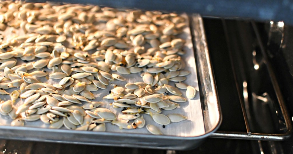 baking sheet with roasted pumpkin seeds in the oven