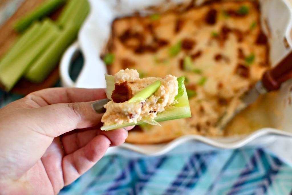 keto game day snacks - dipping celery in cheese bacon dip