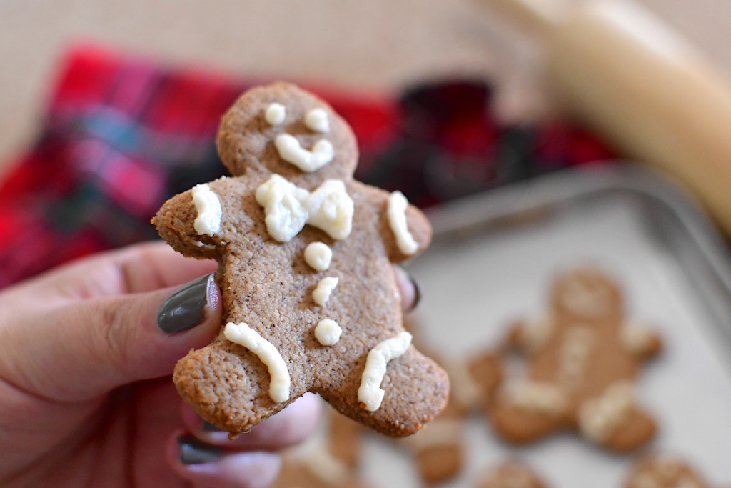 holding frosting keto Gingerbread Man cookie 