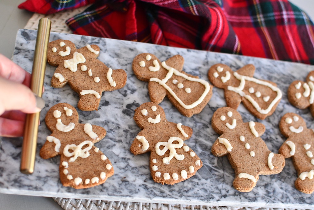 holding tray with frosted keto Gingerbread cookies 