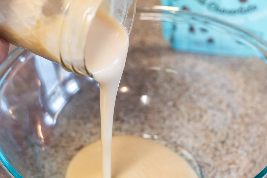 pouring keto condensed milk in bowl 