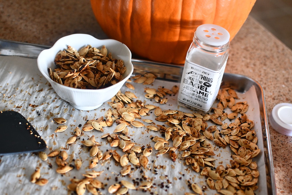 roasted and seasoned pumpkin seeds on pan 