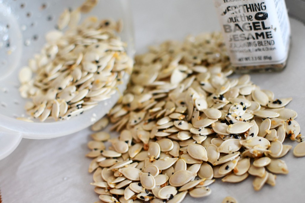 everything bagel pumpkin seeds on a baking tray