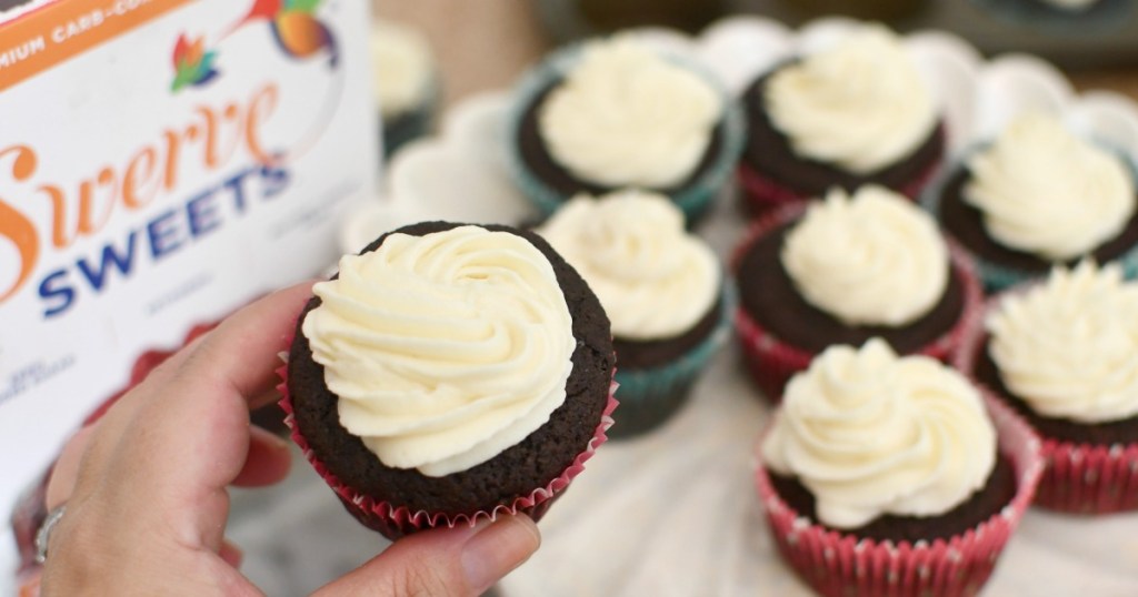 holding a cupcake made with swerve cake mix 