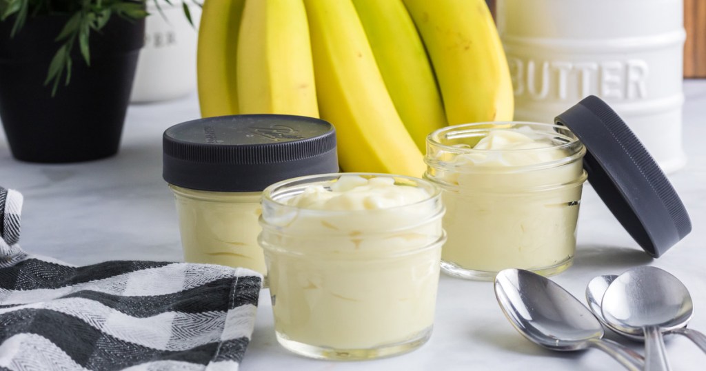 Banana pudding in jars on table