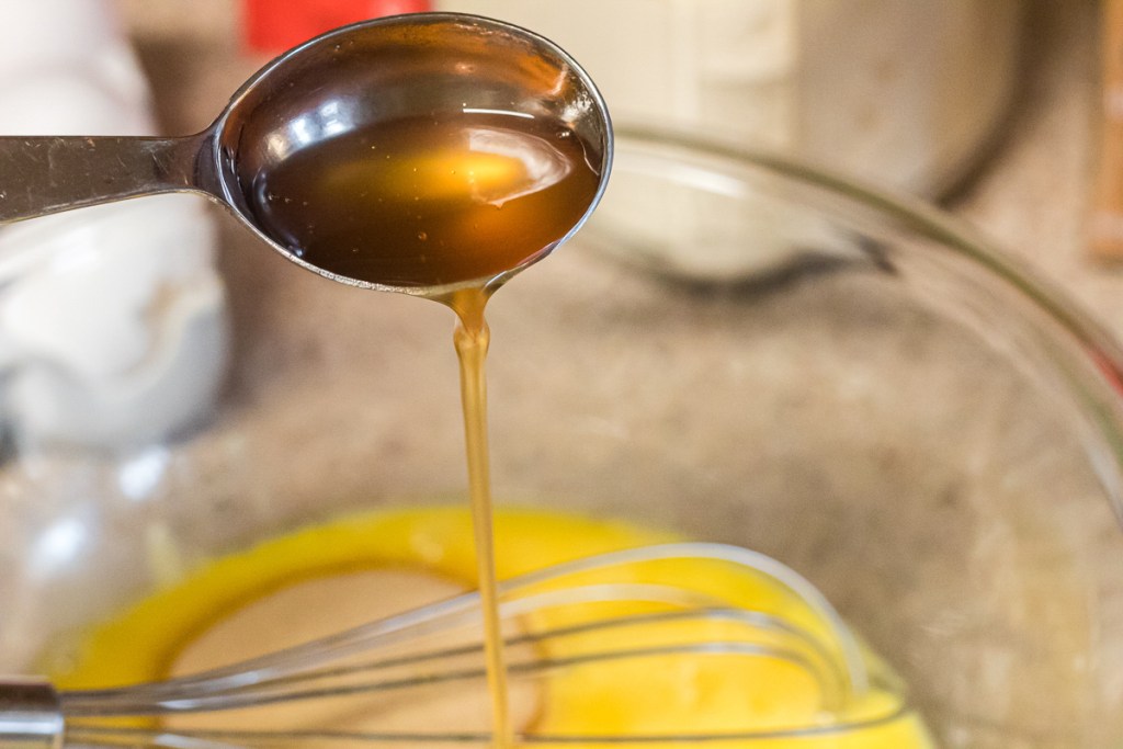 pouring syrup into egg mixture